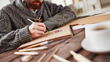 Artist at work Image of young bearded man drawing